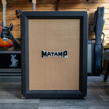 Load image into Gallery viewer, Guitar amplifier with &#39;MATAMP&#39; logo in a music store setting
