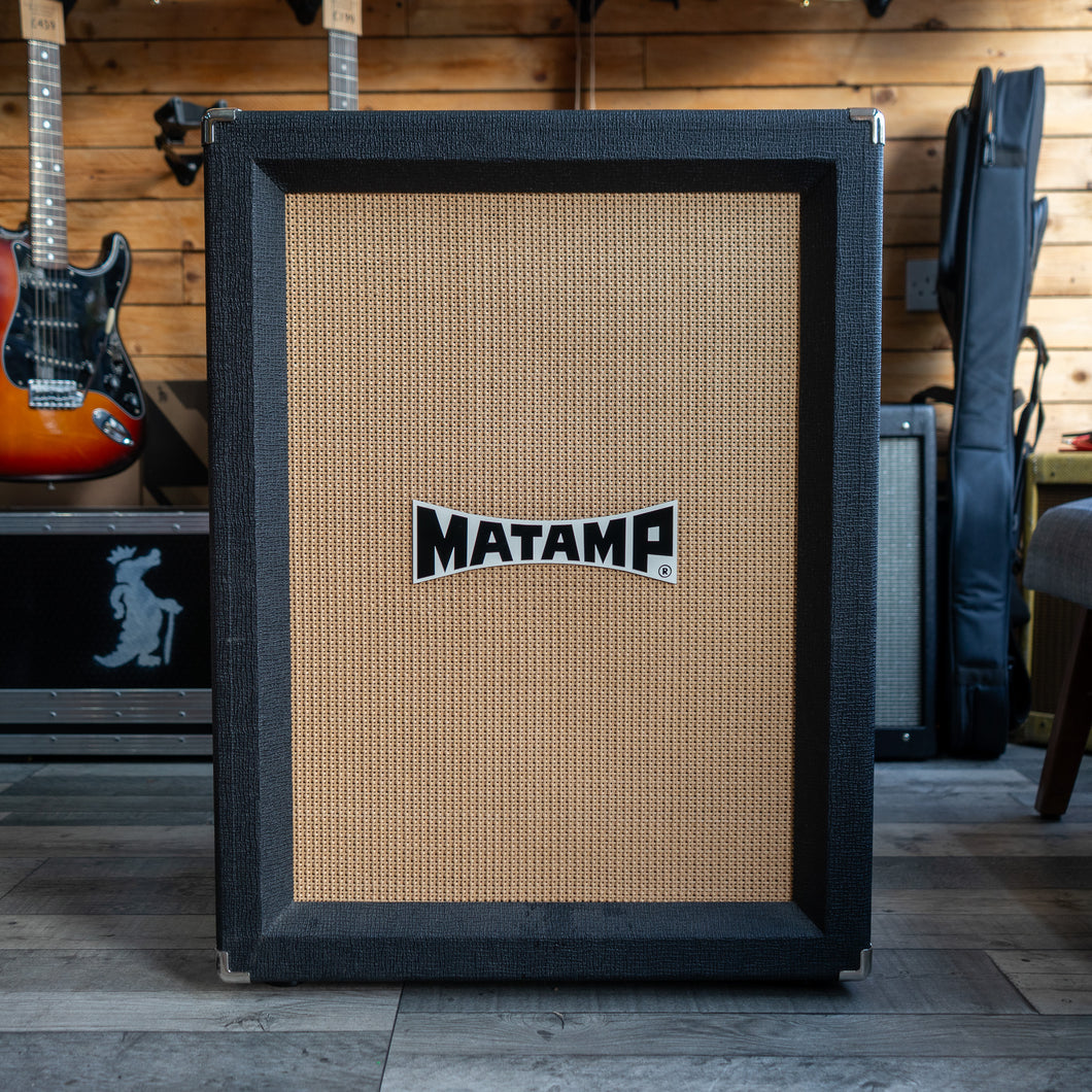Guitar amplifier with 'MATAMP' logo in a music store setting